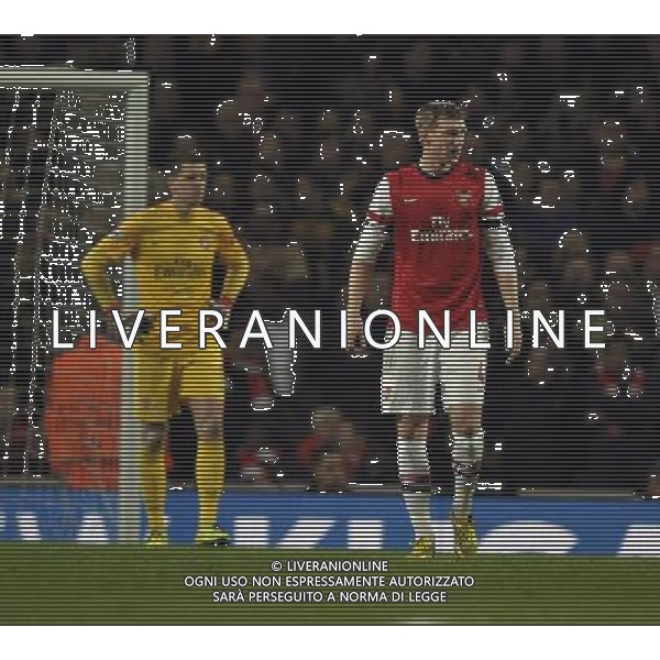 Emirates Stadium Arsenal v Bayern Munich (1-3) Champions League first Knockout Round 19/02/13 Dejected Per Mertesacker and Wojicech Szczesny (Arsenal) as Bayern Munich win convincingly Photo: Roger Parker Fotosports International AG ALDO LIVERANI S A S ONLY ITALY