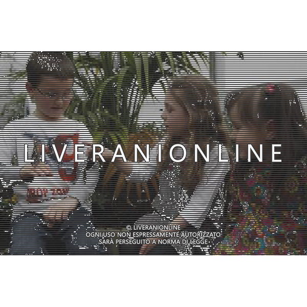 Children play with butterfly in the \'Sensational Butterflies\' exhibition at the Natural History Museum on 25 March, 2013 in London, Britain. The live, tropical butterfly house will be stationed on the Natural History Museum\'s east lawn from March 29, 2013 until September 15, 2013. ©Photoshot/AGENZIA ALDO LIVERANI SAS-ITALY ONLY - EDITORIAL USE ONLY