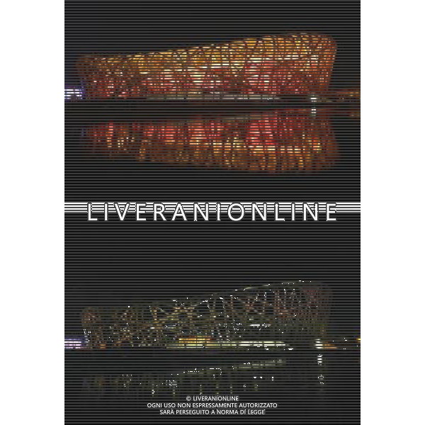 (130323) -- BEIJING, March 23, 2013 () -- The combo China National Stadium, also known as the Bird\'s Nest, before (up) and after turning off its lights to mark the annual \'Earth Hour\' event, Beijing, capital of China, March 23, 2013. (/Wang Zhen) (zn) ©Photoshot/AGENZIA ALDO LIVERANI SAS-ITALY ONLY - EDITORIAL USE ONLY
