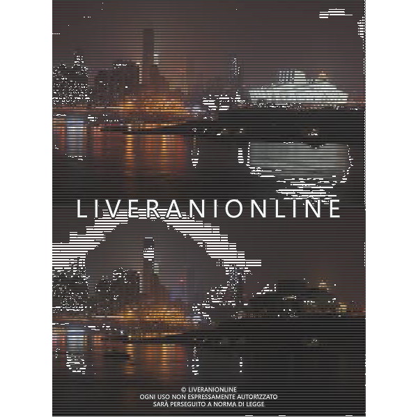 (130323) -- CHONGQING, March 23, 2013 () -- The combo Chongqing Grand Theatre, a newly built symbol of Chongqing, southwest China, before (up) and after turning off its lights to mark the annual \'Earth Hour\' event, March 23, 2013. (/Li Jian) (zn) ©Photoshot/AGENZIA ALDO LIVERANI SAS-ITALY ONLY - EDITORIAL USE ONLY