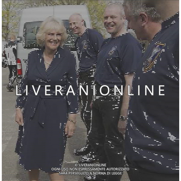 Camilla Duchess of Cornwall talks to members of her police outrider unit known as the \'Special Escort Group\' which is part of the metropolitan police. With her are the celebrity chefs known as the ñHairy Bikersî, Simon King and David Myers, who were with her on a visit to a Community Centre run by Elmbridge Borough Council in Cobham, Surrey. She also highlighted the the importance of the Elmbridge council\'s Meals on Wheels service. The \'Hairy biker\' chefs were there as part of their campaign to revive Meals on Wheels services for pensioners. The duchess also highligted the work being done by Surrey County Council in their Prevention Through Partnership Programme which arranges for services, like Meals on Wheels, to be made available to enable vulnerable people to live independently but with important support in their own homes. Pic: Richard Pohle ©PHOTOSHOT/AGENZIA ALDO LIVERANI SAS - ITALY ONLY - REALI INGLESI: Camilla Duchessa di Cornovaglia