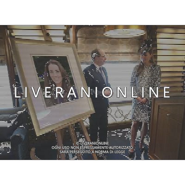 SOUTHAMPTON, ENGLAND - JUNE 13: President and CEO of Princess Cruises Alan Buckelew escorts Catherine, Duchess of Cambridge as she looks at an image of herself during a tour of the Princess Cruises ship after its naming ceremony at Ocean Terminal on June 13, 2013 in Southampton, England. AG ALDO LIVERANI SAS ONLY ITALY