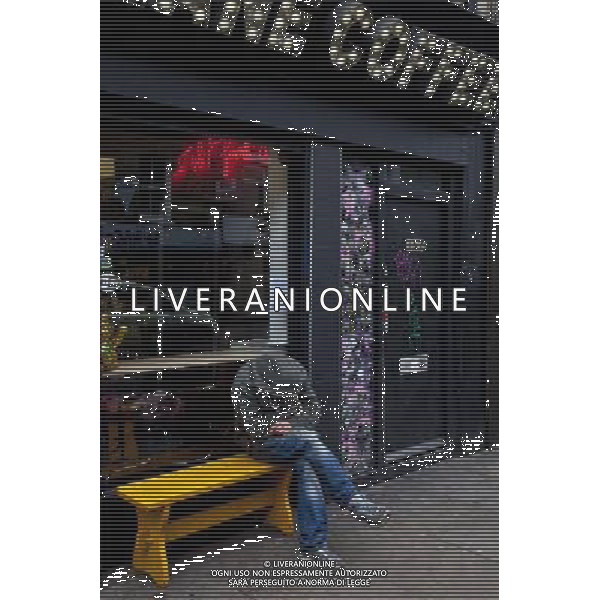 Man asleep outside shop, Brick Lane, London, England AG ALDO LIVERANI SAS ONLY ITALY