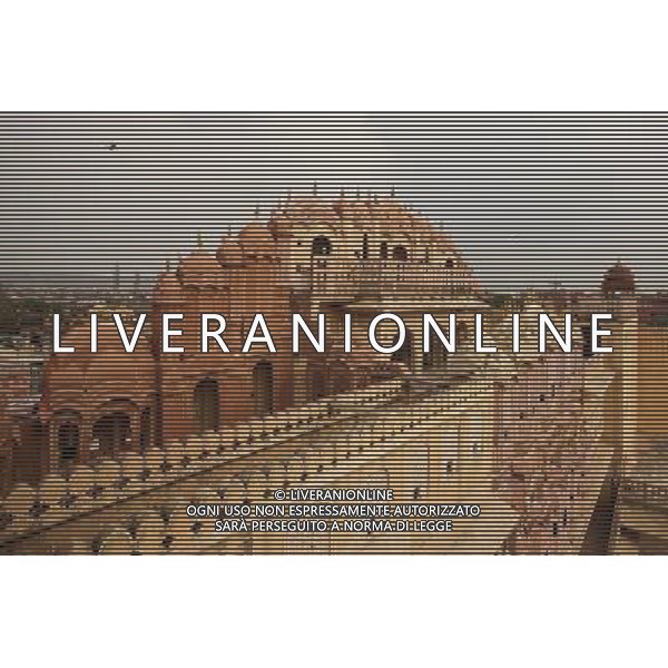 (130613) -- JAIPUR, June 13, 2013 () -- Photo taken on June 13, 2013 shows the Hawa Mahal in Jaipur, capital of Rajasthan, India. The Hawa Mahal, also known as Palace of Winds, is a landmark palace in Jaipur. It was built in 1799 from red and pink sandstone with the intention to allow royal ladies to observe life outside the palace. The lattice on the wall was designed to prevent them from being seen, since they followed strict face cover rules. The Hawa Mahal\'s five-storey exterior has 953 small windows, which together with the lattice provides cool air during the high temperatures in summers. (/Zheng Huansong) ©Photoshot/AGENZIA ALDO LIVERANI SAS-ITALY ONLY - EDITORIAL USE ONLY