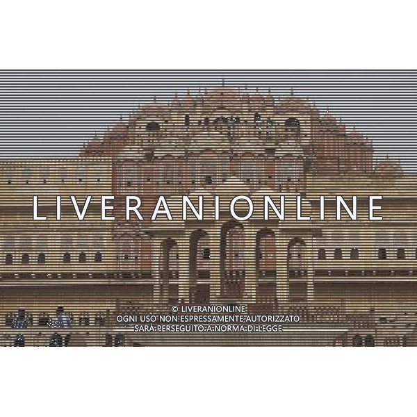(130613) -- JAIPUR, June 13, 2013 () -- People visit the Hawa Mahal in Jaipur, capital of Rajasthan, India, June 13, 2013. The Hawa Mahal, also known as Palace of Winds, is a landmark palace in Jaipur. It was built in 1799 from red and pink sandstone with the intention to allow royal ladies to observe life outside the palace. The lattice on the wall was designed to prevent them from being seen, since they followed strict face cover rules. The Hawa Mahal\'s five-storey exterior has 953 small windows, which together with the lattice provides cool air during the high temperatures in summers. (/Zheng Huansong) ©Photoshot/AGENZIA ALDO LIVERANI SAS-ITALY ONLY - EDITORIAL USE ONLY