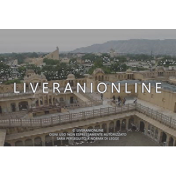 (130613) -- JAIPUR, June 13, 2013 () -- People visit the Hawa Mahal in Jaipur, capital of Rajasthan, India, June 13, 2013. The Hawa Mahal, also known as Palace of Winds, is a landmark palace in Jaipur. It was built in 1799 from red and pink sandstone with the intention to allow royal ladies to observe life outside the palace. The lattice on the wall was designed to prevent them from being seen, since they followed strict face cover rules. The Hawa Mahal\'s five-storey exterior has 953 small windows, which together with the lattice provides cool air during the high temperatures in summers. (/Zheng Huansong) ©Photoshot/AGENZIA ALDO LIVERANI SAS-ITALY ONLY - EDITORIAL USE ONLY