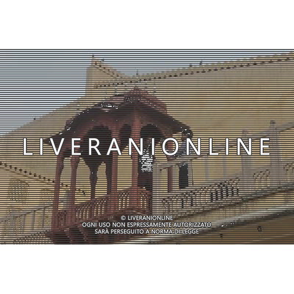 (130613) -- JAIPUR, June 13, 2013 () -- People visit the Hawa Mahal in Jaipur, capital of Rajasthan, India, June 13, 2013. The Hawa Mahal, also known as Palace of Winds, is a landmark palace in Jaipur. It was built in 1799 from red and pink sandstone with the intention to allow royal ladies to observe life outside the palace. The lattice on the wall was designed to prevent them from being seen, since they followed strict face cover rules. The Hawa Mahal\'s five-storey exterior has 953 small windows, which together with the lattice provides cool air during the high temperatures in summers. (/Zheng Huansong) ©Photoshot/AGENZIA ALDO LIVERANI SAS-ITALY ONLY - EDITORIAL USE ONLY