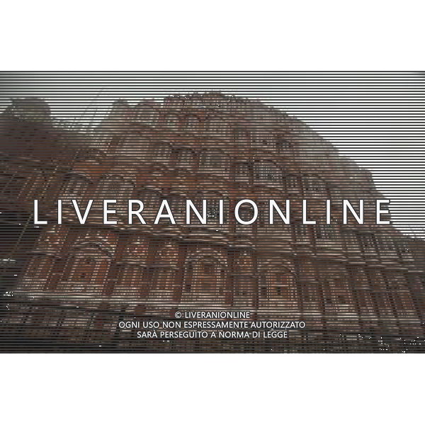 (130613) -- JAIPUR, June 13, 2013 () -- Photo taken on June 13, 2013 shows the Hawa Mahal in Jaipur, capital of Rajasthan, India. The Hawa Mahal, also known as Palace of Winds, is a landmark palace in Jaipur. It was built in 1799 from red and pink sandstone with the intention to allow royal ladies to observe life outside the palace. The lattice on the wall was designed to prevent them from being seen, since they followed strict face cover rules. The Hawa Mahal\'s five-storey exterior has 953 small windows, which together with the lattice provides cool air during the high temperatures in summers. (/Zheng Huansong) ©Photoshot/AGENZIA ALDO LIVERANI SAS-ITALY ONLY - EDITORIAL USE ONLY