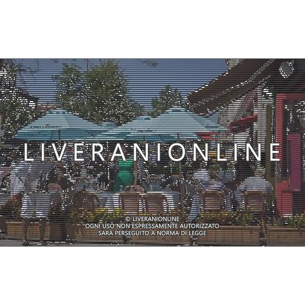 Patrons sit at the outdoor cafe of the Chez Lucienne restaurant on Lenox Avenue in the neighborhood of Harlem in New York on Sunday, June 23, 2013. Wide sidewalks and a renaissance in Harlem have caused a number of restaurants to open catering to the more upwardly mobile newer residents. (Œ Richard B. Levine) ©photoshot/AGENZIA ALDO LIVERANI SAS - ITALY ONLY - Veduta della vita quotidiana e commerciale dei quartieri della citta\' di New York