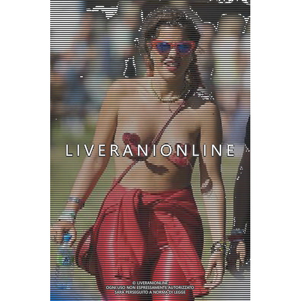 Atmosphere at Glastonbury Festival on 29/06/2013 at Worthy Farm, Glastonbury. Woman walking almost topless with just her nipples covered. ©photoshot/AGENZIA ALDO LIVERANI SAS - ITALY ONLY - EDITORIAL USE ONLY