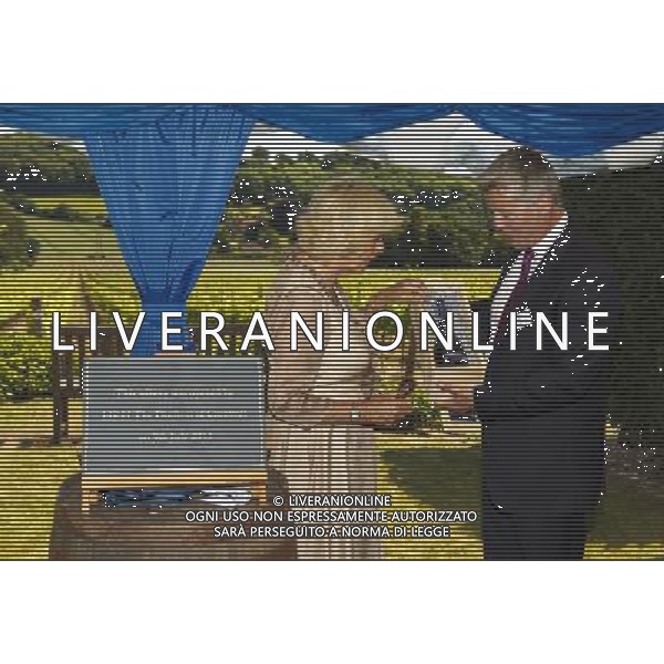 The Duchess of Cornwall receives a gift of the first bottle of sparkling wine produced at Hambledon Vineyard from Managing Director Ian Kellett during her visit to the Hampshire producer where she opened the new facility in her capacity as President of The United Kingdom Vineyards Association. PRESS ASSOCIATION Photo. Picture date: Tuesday July 9, 2013. Hambledon lays claim to being England\'s oldest commercial vineyard. Photo credit should read: Chris Ison/PA Wire ©photoshot/AGENZIA ALDO LIVERANI SAS - ITALY ONLY - REALI INGLESI: Camilla Duchessa di Cornovaglia in visita alla cantina e i vigneti Hambledon nell\'Hampshire, 9 luglio, 2013. Hambledon rivendica di essere il piu\' antico vigneto commerciale dell\'Inghilterra