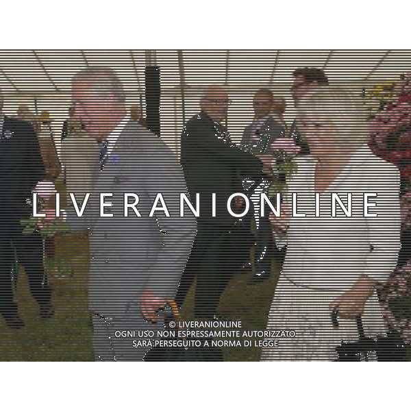 KING\'S LYNN, ENGLAND - JULY 31: Prince Charles, Prince of Wales and Camilla, Duchess of Cornwall hold roses during a visit to the 132nd Sandringham Flower Show at Sandringham House on July 31, 2013 in King\'s Lynn, England. ©photoshot/AGENZIA ALDO LIVERANI SAS - ITALY ONLY - REALI INGLESI: Il principe Carlo d\'inghilterra con la moglie Camilla duchessa di Cornovaglia
