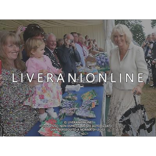 KING\'S LYNN, ENGLAND - JULY 31: Camilla, Duchess of Cornwall is presented with some seeds by 22-month-old Evelyn Holt during a visit to the 132nd Sandringham Flower Show at Sandringham House on July 31, 2013 in King\'s Lynn, England. ©photoshot/AGENZIA ALDO LIVERANI SAS - ITALY ONLY - REALI INGLESI: Il principe Carlo d\'inghilterra con la moglie Camilla duchessa di Cornovaglia