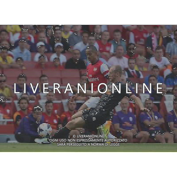 Galatasaray\'s Semih Kaya tackles Arsenal\'s Theo Walcott (Photo by Kieran Galvin/CameraSport) Football - The Emirates Cup - Arsenal v Galatasaray - Sunday 4th August 2013 - The Emirates Stadium - London Œ© CameraSport - 43 Linden Ave. Countesthorpe. Leicester. England. LE8 5PG - Tel: +44 (0) 116 277 4147 - admin@camerasport.com - www.camerasport.com AG ALDO LIVERANI SAS ONLY ITALY