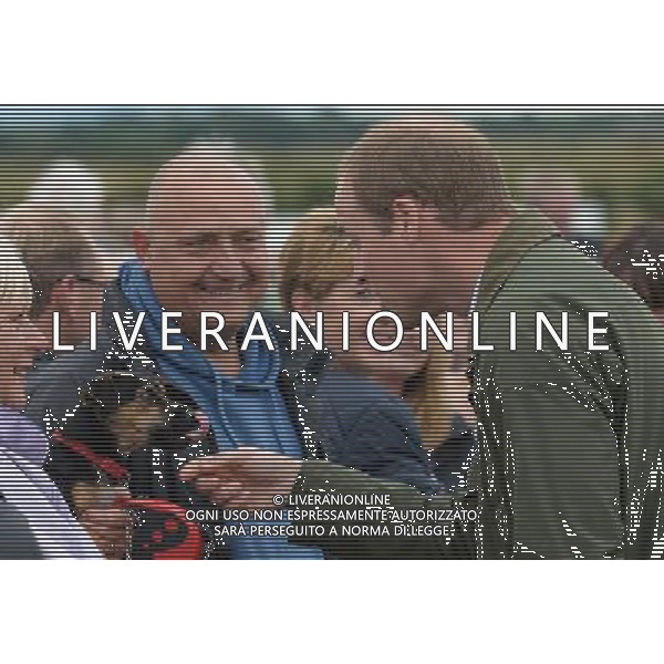 Britain\'s Prince William (R) strokes a dog as he visits the Anglesey Show in North Wales on August 14, 2013. The Anglesey Show is the largest two day agricultural event in North Wales. ©photoshot/AGENZIA ALDO LIVERANI SAS - ITALY ONLY - REALI INGLESI: Il principe William d\'inghilterra alla sua prima uscita ufficiale dopo la nascita del figlio, in visita presso la Mostra Anglesey nel Galles del Nord il 14 agosto 2013