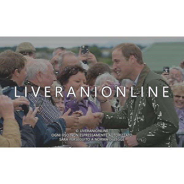 Britain\'s Prince William (R) meets members of the public as he visits the Anglesey Show in North Wales on August 14, 2013. The Anglesey Show is the largest two day agricultural event in North Wales. ©photoshot/AGENZIA ALDO LIVERANI SAS - ITALY ONLY - REALI INGLESI: Il principe William d\'inghilterra alla sua prima uscita ufficiale dopo la nascita del figlio, in visita presso la Mostra Anglesey nel Galles del Nord il 14 agosto 2013