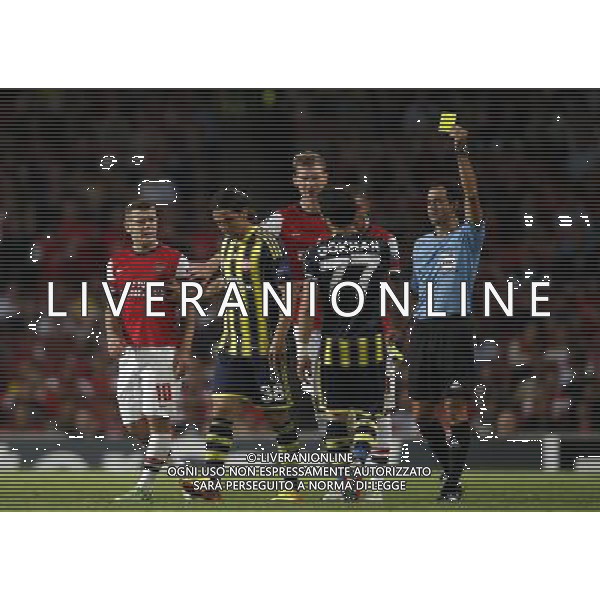 (130828) -- LONDON, Aug. 28, 2013 () -- Spanish referee Carlos Velasco Carballo (1st R) books Fenerbahce\'s Gokhan Gonul (2nd R) after a challenge on Arsenal\'s Jack Wilshere (1st L) during the UEFA Champions League Play-off Round Second leg match between Arsenal FC and Fenerbahce SK at Emirates Stadium in London, Britain on Aug. 27, 2013. Arsenal won 2-0 in this match. Arsenal defeated Fenerbahce with a 5-0 in aggregate to reach the Champions League for the 16th consecutive year.(/Wang Lili)