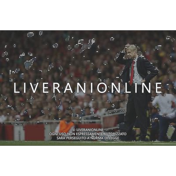 (130828) -- LONDON, Aug. 28, 2013 () -- Arsene Wenger, manager of Arsenal reacts on the touchline during the UEFA Champions League Play-off Round Second leg match between Arsenal FC and Fenerbahce SK at Emirates Stadium in London, Britain on Aug. 28, 2013. Arsenal won 2-0 in this match. Arsenal defeated Fenerbahce with a 5-0 in aggregate to reach the Champions League for the 16th consecutive year.(/Wang Lili)