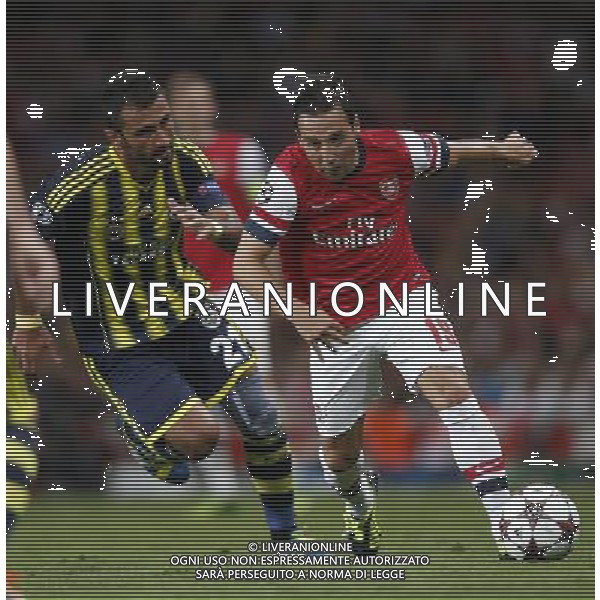 (130828) -- LONDON, Aug. 28, 2013 () -- Santi Cazorla(R) of Arsenal vies with Selcuk Sahin of Fenerbahce during the UEFA Champions League Play-off Round Second leg match between Arsenal FC and Fenerbahce SK at Emirates Stadium in London, Britain on Aug. 27, 2013. Arsenal won 2-0 in this match. Arsenal defeated Fenerbahce with a 5-0 in aggregate to reach the Champions League for the 16th consecutive year.(/Wang Lili)
