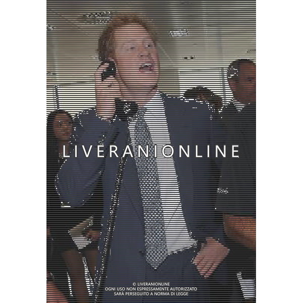 LONDON, ENGLAND - SEPTEMBER 11: Prince Harry takes part in a trade on at the BGC Partners trading floor during the BGC Charity Day 2013 at Canary Wharf on September 11, 2013 in London, England. The event is in memory of those who died in the World Trade Centre attacks and supports a number of UK charities. Prince William, Duke of Cambridge and Prince Harry were involved in a number of multi billion Euro trades during the morning. ©PHOTOSHOT/AGENZIA ALDO LIVERANI SAS - ITALY ONLY - EDITORIAL USE ONLY - REALI INGLESI: il principe Harry e William, durante il Charity Day BGC 2013 Canary Wharf 11 Settembre 2013 a Londra, Inghilterra. L\'evento  in memoria di coloro che sono morti negli attacchi al World Trade Center