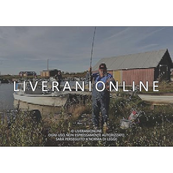 (130910) -- BRUSSELS, Sept 10, 2013 () -- Photo taken on Sept 4, 2013 shows an old man fishing at a samll harbor of Svedjehamn in Kvarken Archipelago, about 40 kilometers north of Vaasa, Finland. The 5,600 islands of Kvarken Archipelago, which is the only admitted UNESCO World Natural Heritage of Finnish, feature unusual ridged washboard moraines, ¡®De Geer moraines¡¯, formed by the melting of the continental ice sheet, 10,000 to 24,000 years ago. The Archipelago is continuously rising from the sea in a process of rapid glacio-isostatic uplift, whereby the land, previously weighed down under the weight of a glacier, lifts at rates that are among the highest in the world. (/Ye Pingfan) ©photoshot/AGENZIA ALDO LIVERANI SAS - ITALY ONLY - EDITORIAL USE ONLY - Veduta dell\'Arcipelago Kvarken a Svedjehamn, circa 40 chilometri a nord di Vaasa, in Finlandia, con le sue 5.600 isole e\' l\'unico iscritto nel patrimonio naturale Mondiale dell\'umanitˆ dell\'UNESCO