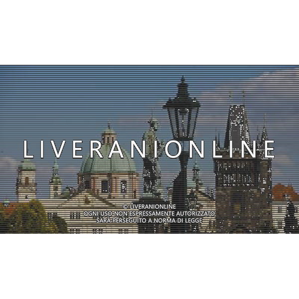 (130912) -- BRUSSELS, Sept. 12, 2013 () -- The photo taken on Sept. 1, 2013 shows the statue on the Charles Bridge and the roofs in the old town of Prague, capital of Czech Republic, As home to a number of famous cultural attractions, the extensive historic centre of Prague has been included in the UNESCO World Heritage List since 1992. In the course of the 1100 years of its existence, Prague¡¯s development can be documented in the architectural expression of many historical periods and their styles. (/Zhou Lei) ©PHOTOSHOT/AGENZIA ALDO LIVERANI SAS - ITALY ONLY - EDITORIAL USE ONLY - Vedute dei monumenti della citta di Praga, capitale della Repubblica Ceca, inserita nella lista del patrimonio mondiale dell\'UNESCO dal 1992.