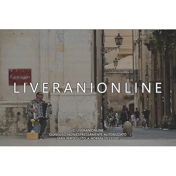 (130920) -- SYRACUSE, Sept. 20, 2013 () -- An artist plays accordion at Piazza Duomo (Cathedral Square) in Ortigia, the old town of Syracuse in Sicily, Italy, Sept. 5, 2013. Located in the southeast corner of the island of Sicily, Syracuse is a historic city in Italy. The 2,700-year-old city founded in 734 or 733 BC by Greek settlers from Corinth and Tenea played a key role in ancient times when it was one of the major powers of the Mediterranean world. Once described by Cicero, renowned Roman philosopher and orator, as \'the greatest Greek city and the most beautiful of them all\', the city was listed by UNESCO as a World Heritage Site along with the Necropolis of Pantalica in 2005. (/Zhou Lei) ©PHOTOSHOT/AGENZIA ALDO LIVERANI SAS - ITALY ONLY - EDITORIAL USE ONLY