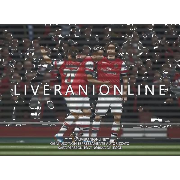 Arsenal\'s Mesut Ozil celebrates scoring his sides first goal Photo by Kieran Galvin/CameraSport Football - UEFA Champions League Group F - Arsenal v Napoli - Tuesday 1st October 2013 - The Emirates Stadium - London Œ© CameraSport - 43 Linden Ave. Countesthorpe. Leicester. England. LE8 5PG - Tel: +44 (0) 116 277 4147 - admin@camerasport.com - www.camerasport.com AG ALDO LIVERANI SAS ONLY ITALY