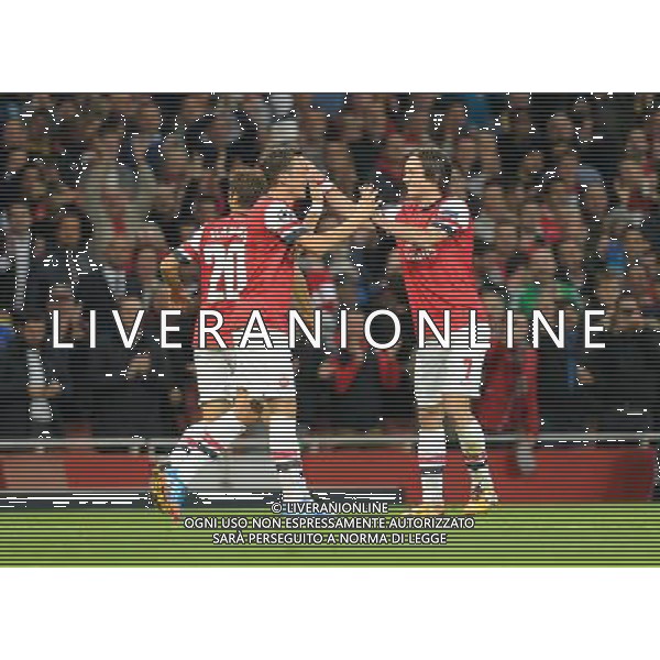  Mesut Ozil and Tomas Rosicky celebrate Arsenal\'s first goal in the Champions League match between Arsenal and Napoli. Held at the Emirates Stadium, London, on Tuesday October 01, 2013. ©photoshot/AGENZIA ALDO LIVERANI SAS - ITALY ONLY - EDITORIAL USE ONLY