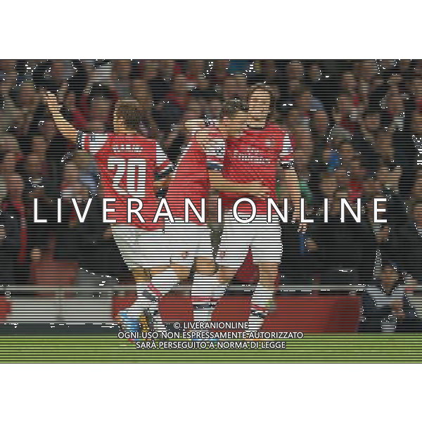  Mesut Ozil and Tomas Rosicky celebrate Arsenal\'s first goal in the Champions League match between Arsenal and Napoli. Held at the Emirates Stadium, London, on Tuesday October 01, 2013. ©photoshot/AGENZIA ALDO LIVERANI SAS - ITALY ONLY - EDITORIAL USE ONLY