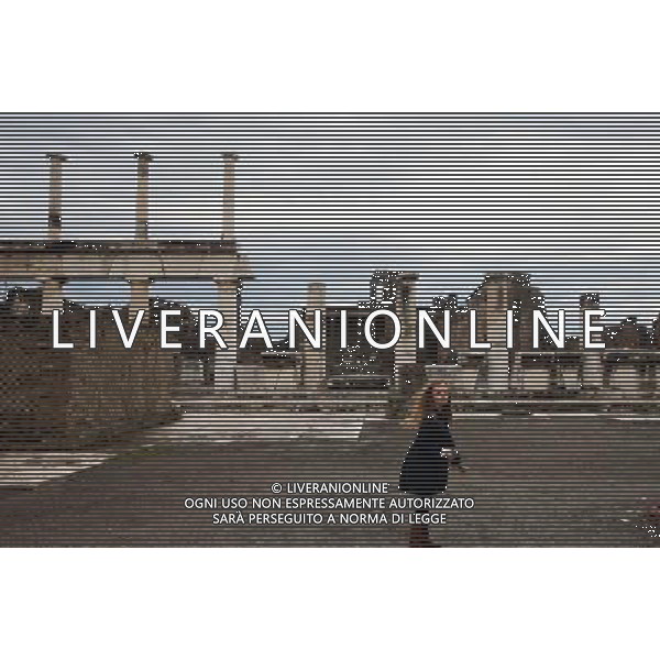 (131012) -- BEIJING, Oct. 12, 2013 () -- Photo taken on Oct. 5, 2013 shows a girl playing on the fprum of Pompei, Italy. When Vesuvius erupted on Aug. 24, AD 79, it engulfed the flourishing Roman towns of Pompei. These have been progressively excavated and made accessible to the public since the mid-18th century, reappearing the vast expanse of the commercial town of Pompei. The UNESCO Commitee inscribed Archaeological Areas of Pompei, Herculaneum and Torre Annunziata as a world heritage site in 1997. (/Du Juanjuan) ©Photoshot/Ag. Aldo Liverani s.a.s.-Only Italy-Editorial Use Only