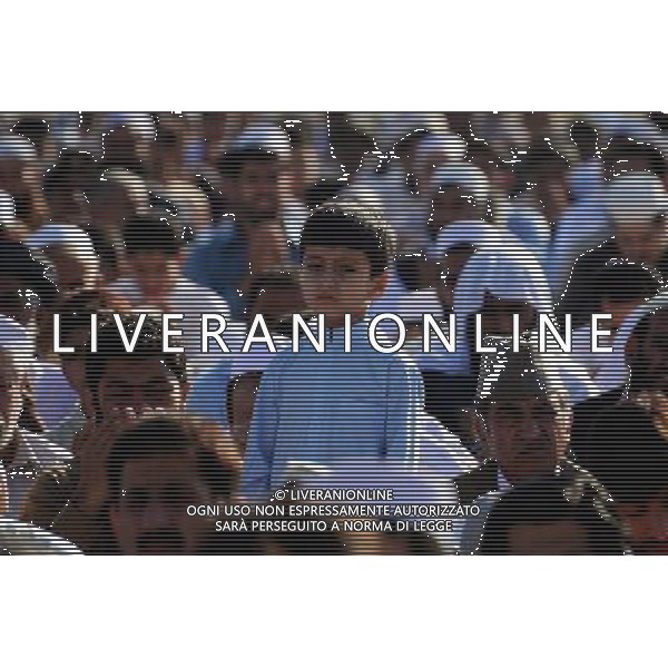 (131015) -- PESHAWAR, Oct. 15, 2013 () -- An Afghan refugee boy stands as others offer Eid al-Adha prayers on the outskirts of northwest Pakistan\'s Peshawar, Oct. 15, 2013. (/Umar Qayyum) ©photoshot/AGENZIA ALDO LIVERANI SAS - ITALY ONLY - I musulmani di tutto il mondo festeggiano con la macellazione di animali, il primo giorno di Eid al-Adha, o Festa del Sacrificio, il 16 ottobre 2013.