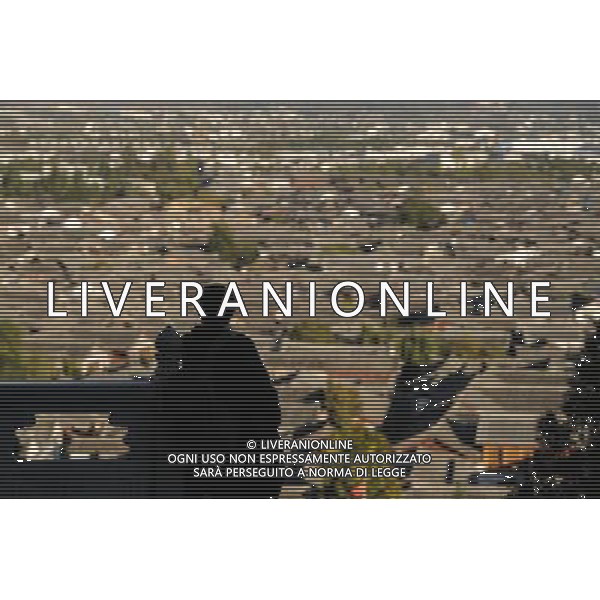 (131112) -- LIJIANG, Nov. 12, 2013 () -- A tourist overlooks the town from the scenic spot of the Lion Mountain in the old town of Lijiang, southwest China\'s Yunnan Province, Nov. 6, 2013. (/Shen Hong) (mp) ©photoshot/AGENZIA ALDO LIVERANI SAS - ITALY ONLY - La popolazione e le abitazioni della citta\' vecchia di Lijiang, Cina sud-occidentale dello Yunnan Provincia , 6 novembre 2013.