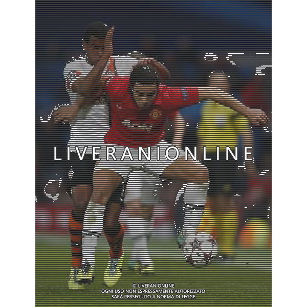 (131211) -- MANCHESTER, Dec. 11, 2013 () -- Rafael Pereira da Silva (R) of Manchester United vies with Fernando Lucas Martins of Shakhtar Donetsk during the UEFA Champions League Group A match between Manchester United and Shakhtar Donetsk at Old Trafford Stadium in Manchester, Britain on Dec. 10, 2013. Manchester United won 1-0. (/Wang Lili) AG ALDO LIVERANI SAS ONLY ITALY