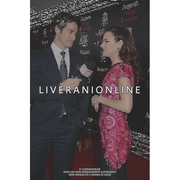 Rob Marciano and Juliette Lewis in Naaen Khan pink flowered embroidered dress attends the New York Premiere of \'August: Osage County\' on December 12, 2013 at the Ziegfeld Theatre in New York City. AG ALDO LIVERANI SAS ONLY ITALY