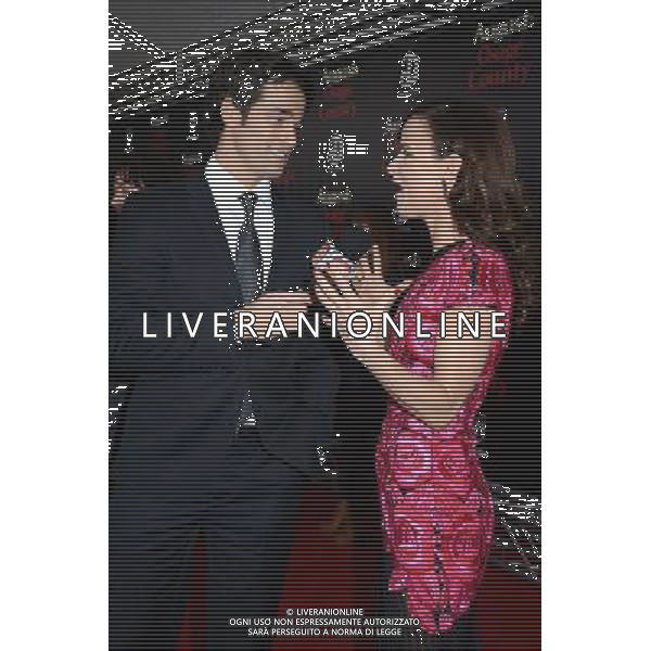 Rob Marciano and Juliette Lewis in Naaen Khan pink flowered embroidered dress attends the New York Premiere of \'August: Osage County\' on December 12, 2013 at the Ziegfeld Theatre in New York City. AG ALDO LIVERANI SAS ONLY ITALY