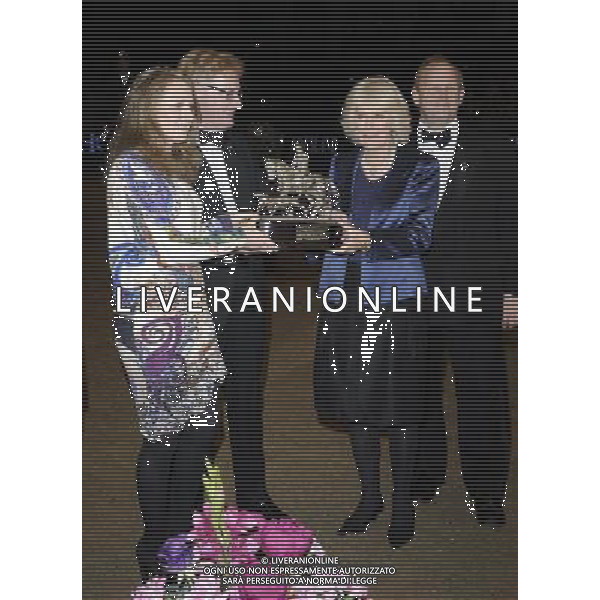 LONDON, UNITED KINGDOM - DECEMBER 19: Camilla, Duchess of Cornwall presents the Raymond Brooks-Ward Memorial Trophy to Louise Saywell during The London International Horse show at Olympia Exhibition Centre on December 19, 2013 in London, England. ©PHOTOSHOT/AGENZIA ALDO LIVERANI SAS - ITALY ONLY - EDITORIAL USE ONLY - REALI INGLESI: Camilla Duchessa di Cornovaglia alla mostra internazionale di cavalli all\'Olympia Exhibition Centre a Londra, Inghilterra 19 dicembre 2013
