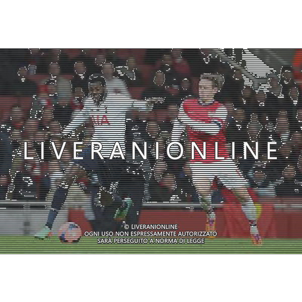 Tottenham Hotspur\'s Emmanuel Adebayor despite the attentions of Arsenal\'s Nacho Monreal Photo by Kieran Galvin/CameraSport Football - FA Challenge Cup Third Round - Arsenal v Tottenham Hotspur - Saturday 4th January 2014 - Emirates Stadium - London © CameraSport - 43 Linden Ave. Countesthorpe. Leicester. England. LE8 5PG - Tel: +44 (0) 116 277 4147 - admin@camerasport.com - www.camerasport.com AG ALDO LIVERANI SAS ONLY ITALY