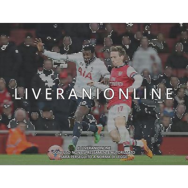 Tottenham Hotspur\'s Emmanuel Adebayor despite the attentions of Arsenal\'s Nacho Monreal Photo by Kieran Galvin/CameraSport Football - FA Challenge Cup Third Round - Arsenal v Tottenham Hotspur - Saturday 4th January 2014 - Emirates Stadium - London © CameraSport - 43 Linden Ave. Countesthorpe. Leicester. England. LE8 5PG - Tel: +44 (0) 116 277 4147 - admin@camerasport.com - www.camerasport.com AG ALDO LIVERANI SAS ONLY ITALY