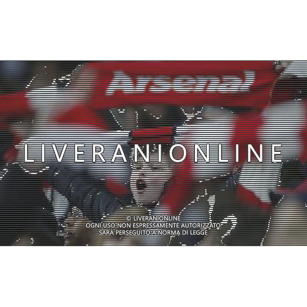 (140105) -- LONDON, Jan. 5, 2014 () -- Fans of Arsenal cheer during FA Cup Third Round match between Arsenal and Tottenham Hotspur at Emirates Stadium in London, Britain on Jan. 4, 2014. Arsenal won 2-0. (/Wang Lili) FOR EDITORIAL USE ONLY. NOT FOR SALE FOR MARKETING OR ADVERTISING CAMPAIGNS. NO USE WITH UNAUTHORIZED AUDIO, VIDEO, DATA, FIXTURE LISTS, CLUBLEAGUE LOGOS OR LIVE SERVICES. ONLINE IN-MATCH USE LIMITED TO 45 IMAGES, NO VIDEO EMULATION. NO USE IN BETTING, GAMES OR SINGLE CLUBLEAGUEPLAYER PUBLICATIONS. AG ALDO LIVERANI SAS ONLY ITALY