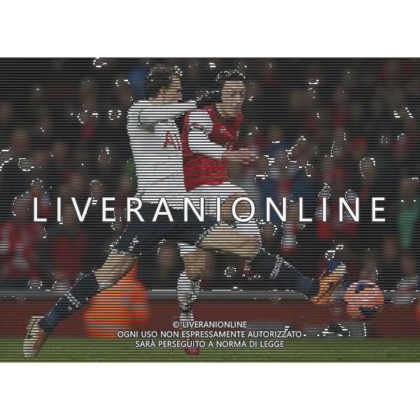 (140105) -- LONDON, Jan. 5, 2014 () -- Mesut Ozil (R) of Arsenal shoots against the defense from Vlad Chiriches of Tottenham Hotspur during FA Cup Third Round match between Arsenal and Tottenham Hotspur at Emirates Stadium in London, Britain on Jan. 4, 2014. Arsenal won 2-0. (/Wang Lili) FOR EDITORIAL USE ONLY. NOT FOR SALE FOR MARKETING OR ADVERTISING CAMPAIGNS. NO USE WITH UNAUTHORIZED AUDIO, VIDEO, DATA, FIXTURE LISTS, CLUBLEAGUE LOGOS OR LIVE SERVICES. ONLINE IN-MATCH USE LIMITED TO 45 IMAGES, NO VIDEO EMULATION. NO USE IN BETTING, GAMES OR SINGLE CLUBLEAGUEPLAYER PUBLICATIONS. AG ALDO LIVERANI SAS ONLY ITALY