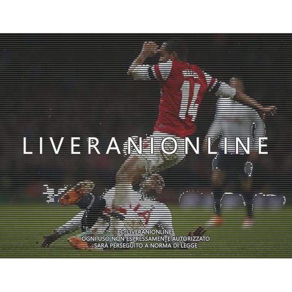 (140105) -- LONDON, Jan. 5, 2014 () -- Theo Walcott (above) of Arsenal is tackled by Danny Rose of Tottenham Hotspur during FA Cup Third Round match between Arsenal and Tottenham Hotspur at Emirates Stadium in London, Britain on Jan. 4, 2014. Arsenal won 2-0. (/Wang Lili) FOR EDITORIAL USE ONLY. NOT FOR SALE FOR MARKETING OR ADVERTISING CAMPAIGNS. NO USE WITH UNAUTHORIZED AUDIO, VIDEO, DATA, FIXTURE LISTS, CLUBLEAGUE LOGOS OR LIVE SERVICES. ONLINE IN-MATCH USE LIMITED TO 45 IMAGES, NO VIDEO EMULATION. NO USE IN BETTING, GAMES OR SINGLE CLUBLEAGUEPLAYER PUBLICATIONS. AG ALDO LIVERANI SAS ONLY ITALY