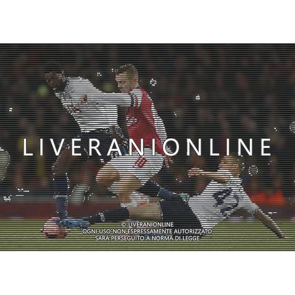 (140105) -- LONDON, Jan. 5, 2014 () -- Jack Wilshere (C) of Arsenal vies with Emmanuel Adebayor (L) and Nabil Bentaleb of Tottenham Hotspur during FA Cup Third Round match between Arsenal and Tottenham Hotspur at Emirates Stadium in London, Britain on Jan. 4, 2014. Arsenal won 2-0. (/Wang Lili) FOR EDITORIAL USE ONLY. NOT FOR SALE FOR MARKETING OR ADVERTISING CAMPAIGNS. NO USE WITH UNAUTHORIZED AUDIO, VIDEO, DATA, FIXTURE LISTS, CLUBLEAGUE LOGOS OR LIVE SERVICES. ONLINE IN-MATCH USE LIMITED TO 45 IMAGES, NO VIDEO EMULATION. NO USE IN BETTING, GAMES OR SINGLE CLUBLEAGUEPLAYER PUBLICATIONS. AG ALDO LIVERANI SAS ONLY ITALY