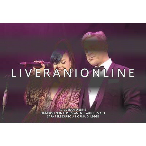  Lily Allen and Robbie Williams on stage at the \'Under 1 Roof\' concert, held at Hammersmith Apollo, London, on Thursday December 19, 2013. AG ALDO LIVERANI SAS ONLY ITALY