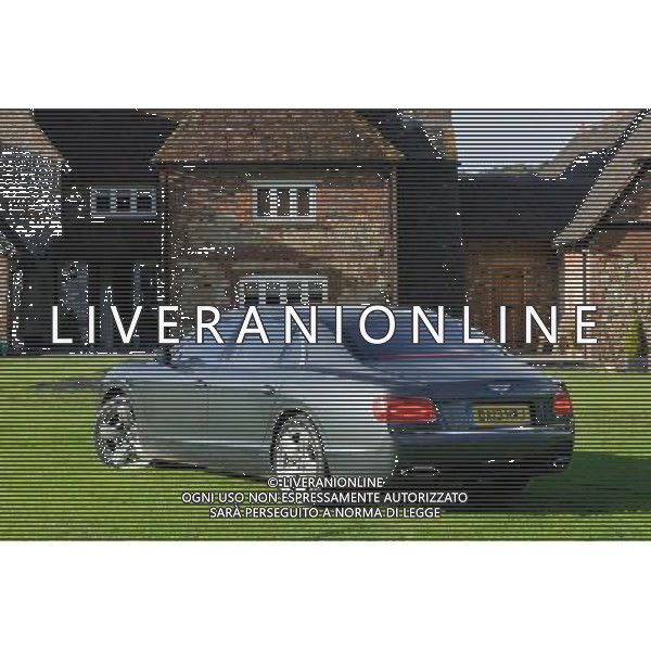 A Bentley Continental Flying Spur seen in a garden of an English country house Bentley Flying Spur /Ag. Aldo Liverani s.a.s.-Only Italy-Editorial Use Only