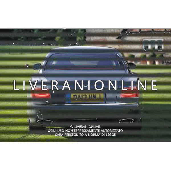 A Bentley Continental Flying Spur seen in a garden of an English country house Bentley Flying Spur /Ag. Aldo Liverani s.a.s.-Only Italy-Editorial Use Only
