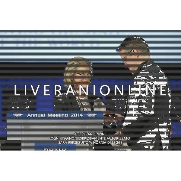 DAVOS/SWITZERLAND, 21JAN14 - Matt Damon (R), Actor and Co-Founder, Water.org, USA receives the crystal award from Hilde Schwab (L), Chairperson and Co-Founder, Schwab Foundation for Social Entrepreneurship, Switzerland during the Annual Meeting 2014 of the World Economic Forum at the congress centre in Davos, January 21, 2014. WORLD ECONOMIC FORUM/swiss-image.ch/Photo Michael Buholzer Â©Photoshot/Ag. Aldo Liverani s.a.s.-Only Italy-Editorial Use Only