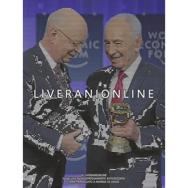 Klaus Schwab (L), Founder and Executive Chairman, World Economic Forum honours Shimon Peres (R), President of Israel with the Global Leadership Award and a Swiss cowbell during the session \'Celebrating the Spirit of Davos\' at the Annual Meeting 2014 of the World Economic Forum at the congress centre in Davos, January 24, 2014. WORLD ECONOMIC FORUM/swiss-image.ch/Photo Remy Steinegger ©Photoshot/Ag. Aldo Liverani s.a.s.-Only Italy-Editorial Use Only