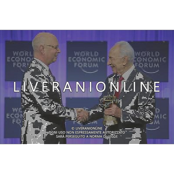 Klaus Schwab (L), Founder and Executive Chairman, World Economic Forum congratulates Shimon Peres (R), President of Israel holding the Swiss Cowbell during the session \'Celebrating the Spirit of Davos\' at the Annual Meeting 2014 of the World Economic Forum at the congress centre in Davos, January 24, 2014. WORLD ECONOMIC FORUM/swiss-image.ch/Photo Remy Steinegger ©Photoshot/Ag. Aldo Liverani s.a.s.-Only Italy-Editorial Use Only