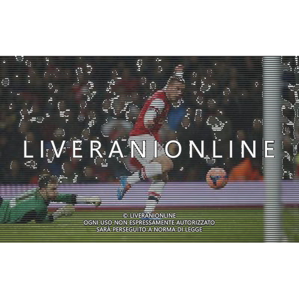 (140125) -- LONDON, Jan. 25, 2014 () -- Lukas Podolski(R) of Arsenal scores his first goal after passing Joe Murphy, the goalie of Coventry City during FA Cup Fourth Round match between Arsenal and Coventry City at Emirates Stadium in London, Britain on Jan. 24, 2014. Arsenal won 4-0. (/Wang Lili) FOR EDITORIAL USE ONLY. NOT FOR SALE FOR MARKETING OR ADVERTISING CAMPAIGNS. NO USE WITH UNAUTHORIZED AUDIO, VIDEO, DATA, FIXTURE LISTS, CLUBLEAGUE LOGOS OR LIVE SERVICES. ONLINE IN-MATCH USE LIMITED TO 45 IMAGES, NO VIDEO EMULATION. NO USE IN BETTING, GAMES OR SINGLE CLUBLEAGUEPLAYER PUBLICATIONS. AG ALDO LIVERANI SAS ONLY ITALY
